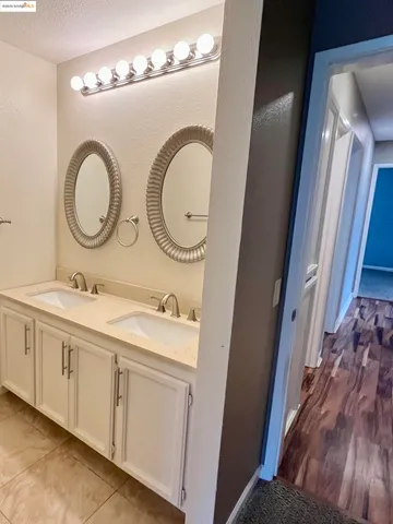a bathroom with a double vanity sink and a mirror
