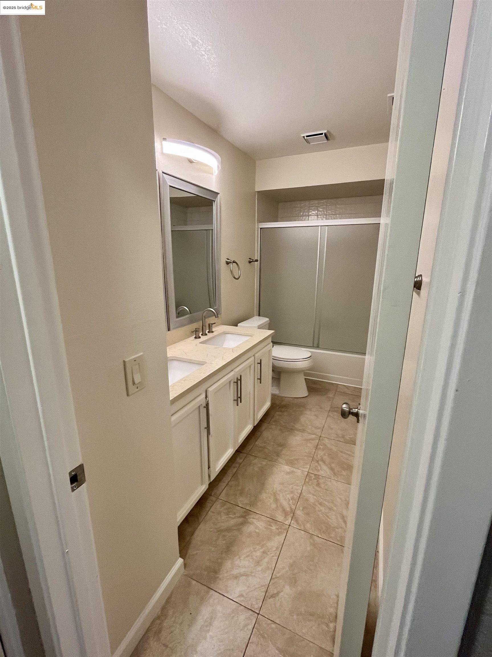5796 Cutter Loop Discovery Bay, CA 94505 - Photo 23 of 29 a bathroom with a sink a toilet and a mirror