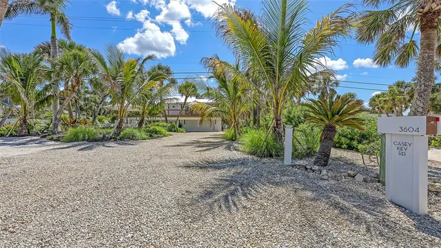 a bathroom with a granite countertop sink mirror vanity bathtub and toilet