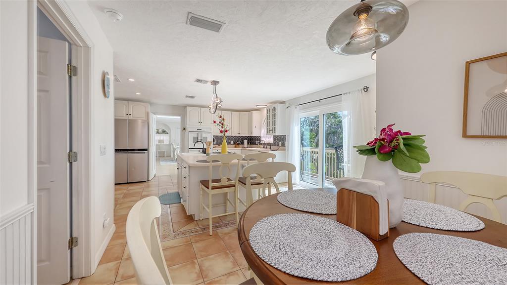 3604 Casey Key Road Nokomis, FL 34275 - Photo 25 of 94 a dining room with furniture a livingroom and chandelier