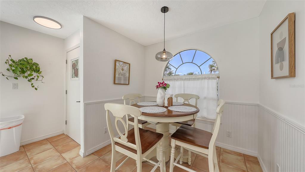 3604 Casey Key Road Nokomis, FL 34275 - Photo 26 of 94 a view of a dining room with furniture and wooden floor