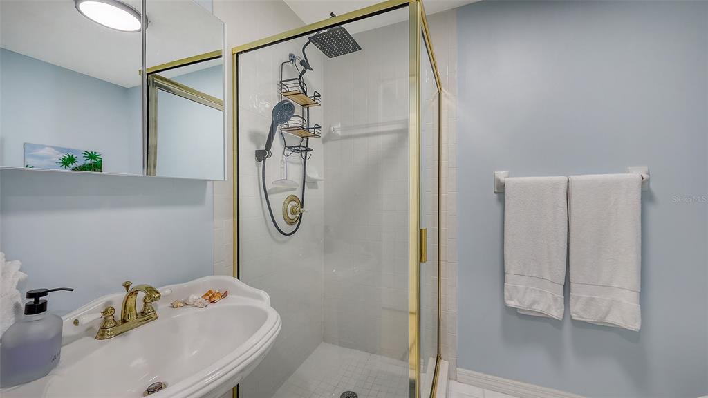 3604 Casey Key Road Nokomis, FL 34275 - Photo 33 of 94 a bathroom with a bathtub and shower