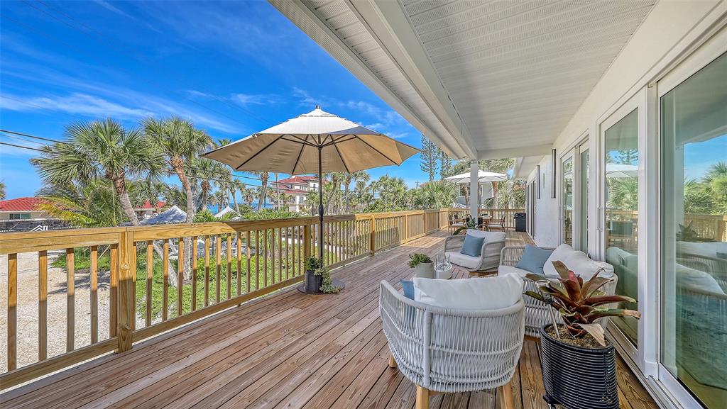 3604 Casey Key Road Nokomis, FL 34275 - Photo 37 of 94 a view of balcony with furniture and umbrella