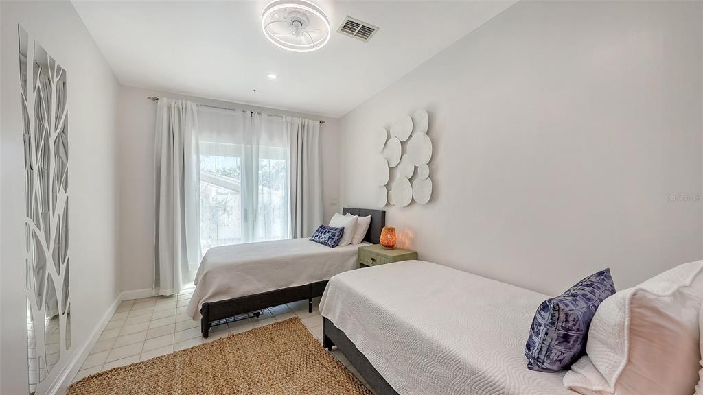 3604 Casey Key Road Nokomis, FL 34275 - Photo 45 of 94 a bedroom with a bed and a window