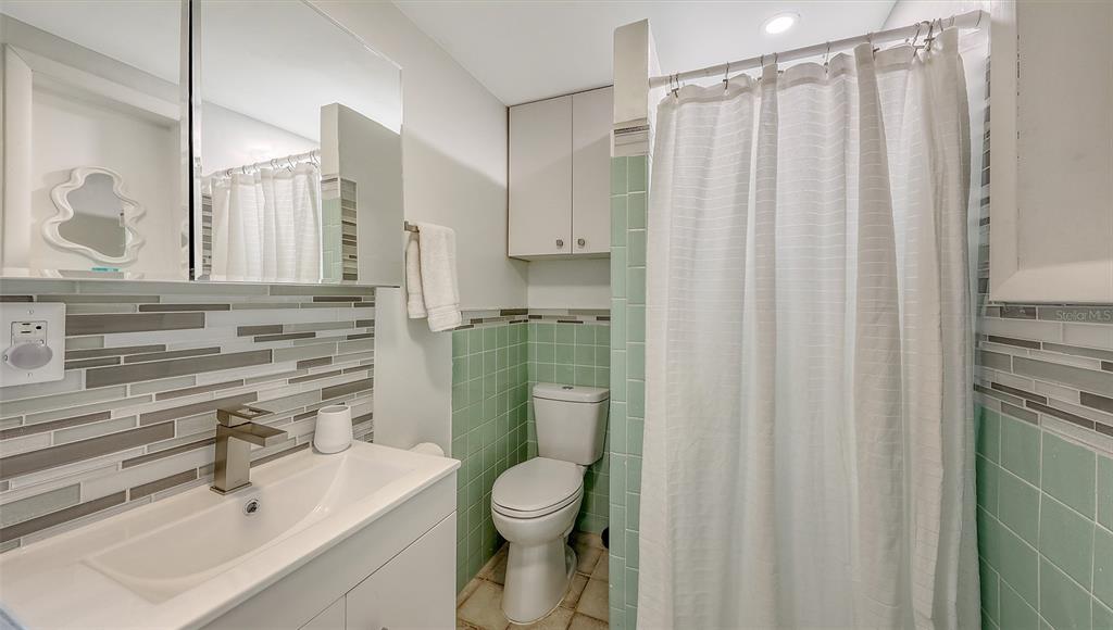 3604 Casey Key Road Nokomis, FL 34275 - Photo 49 of 94 a bathroom with a sink a toilet and shower