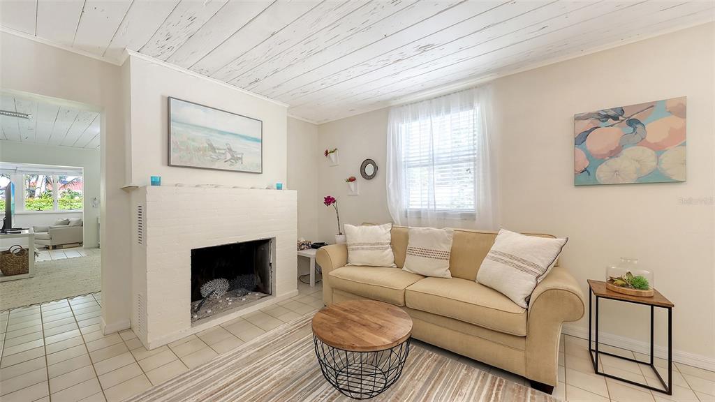 3604 Casey Key Road Nokomis, FL 34275 - Photo 51 of 94 a living room with furniture a rug and a fireplace