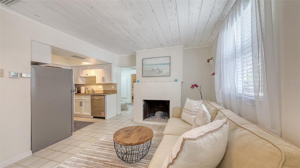 3604 Casey Key Road Nokomis, FL 34275 - Photo 54 of 94 a living room with furniture a fireplace and a table