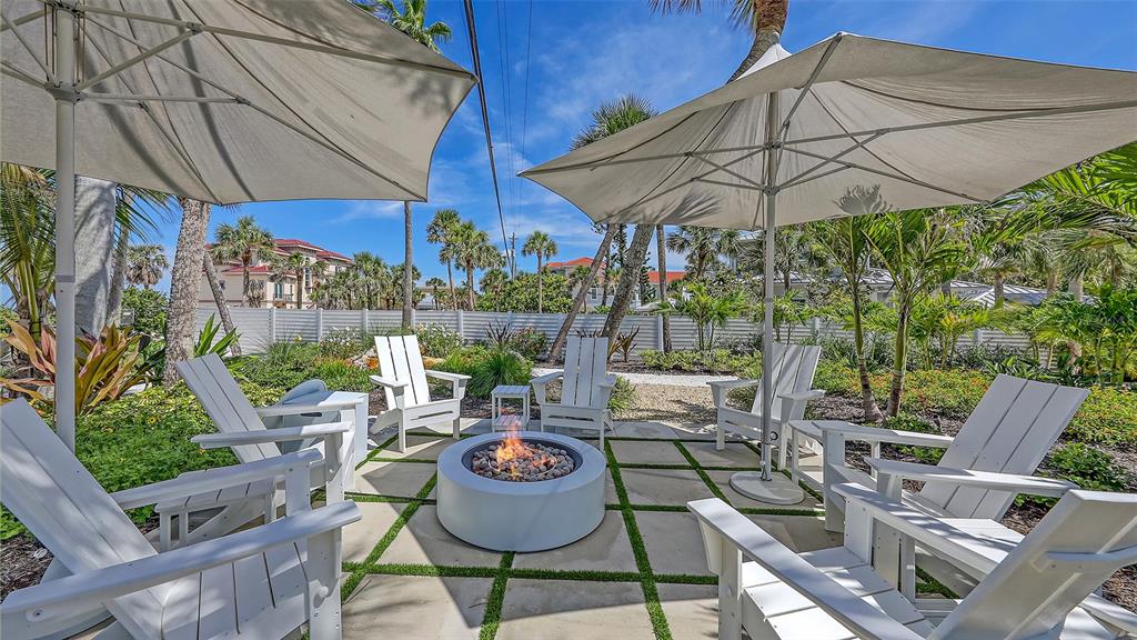 3604 Casey Key Road Nokomis, FL 34275 - Photo 75 of 94 a patio with a patio table and chairs