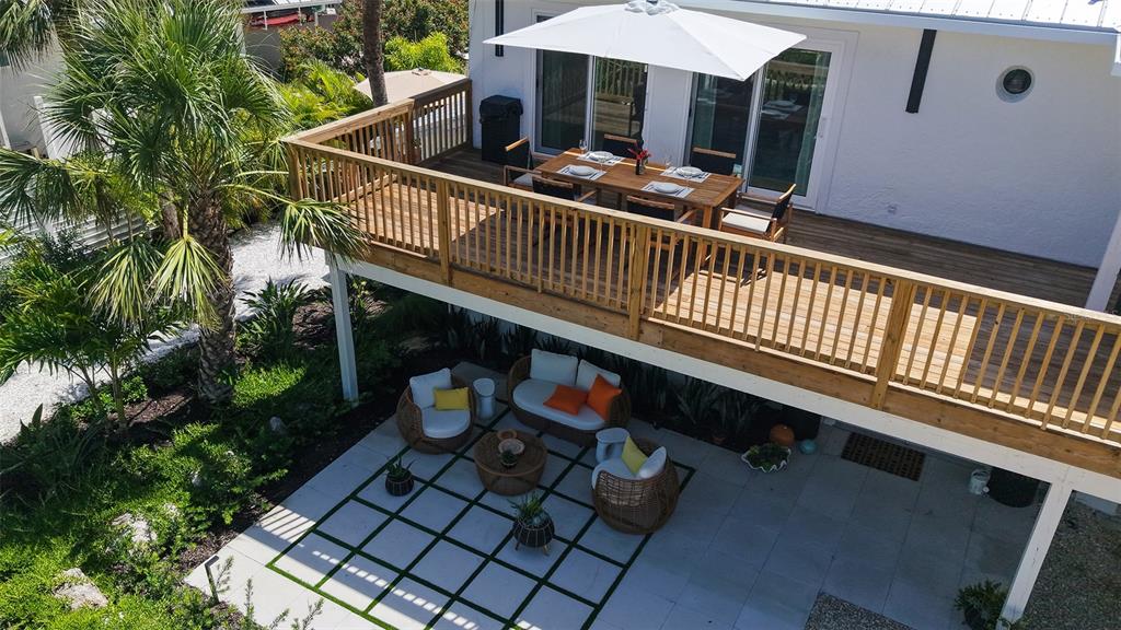 3604 Casey Key Road Nokomis, FL 34275 - Photo 84 of 94 a view of backyard with deck and outdoor seating