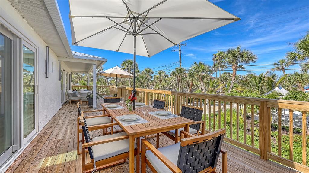 3604 Casey Key Road Nokomis, FL 34275 - Photo 10 of 94 a view of a balcony with furniture and wooden floor