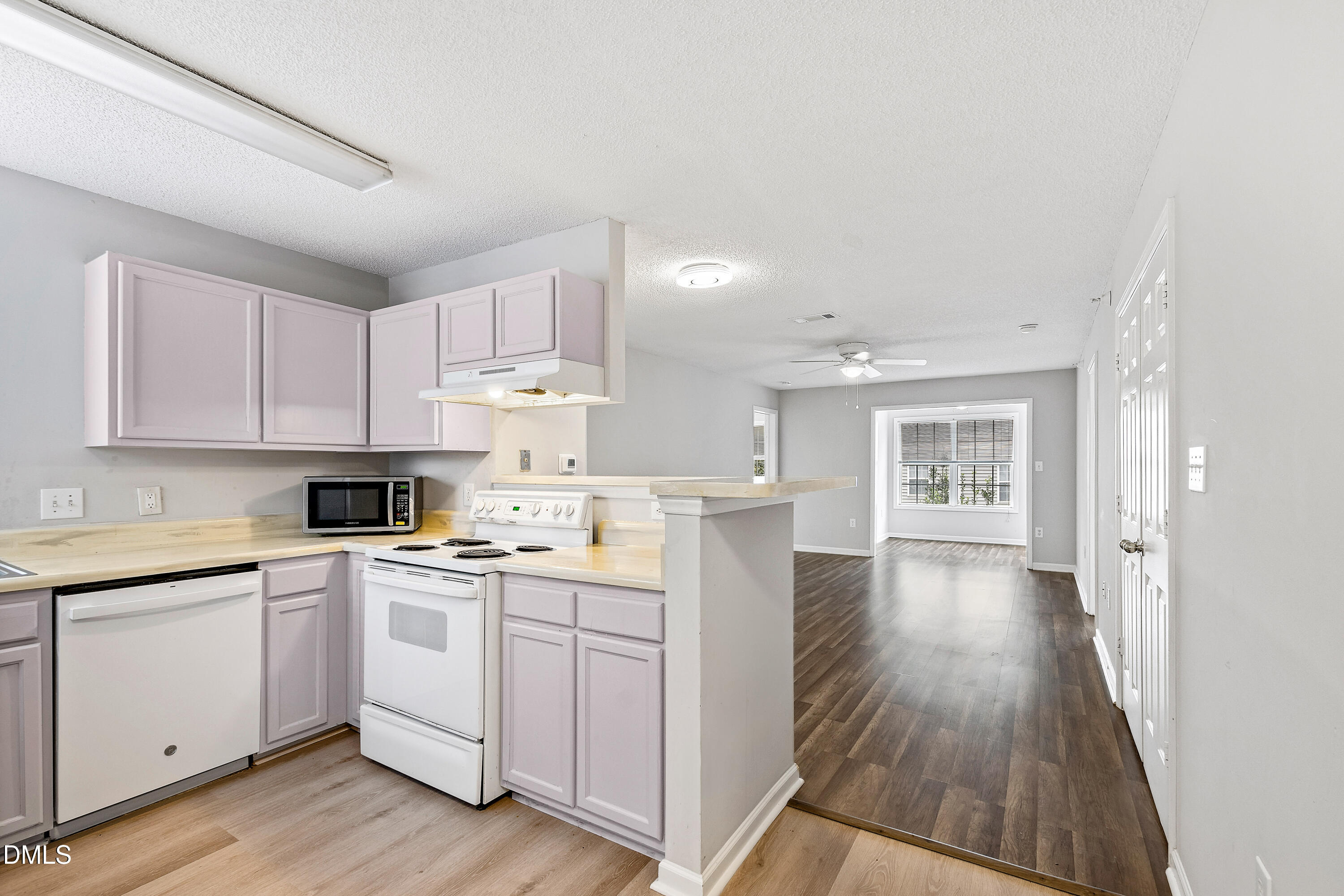 2100 Wolf Tech Lane, Unit 204 Raleigh, NC 27603 - Photo 11 of 40 a kitchen with a sink a stove cabinets and wooden floor