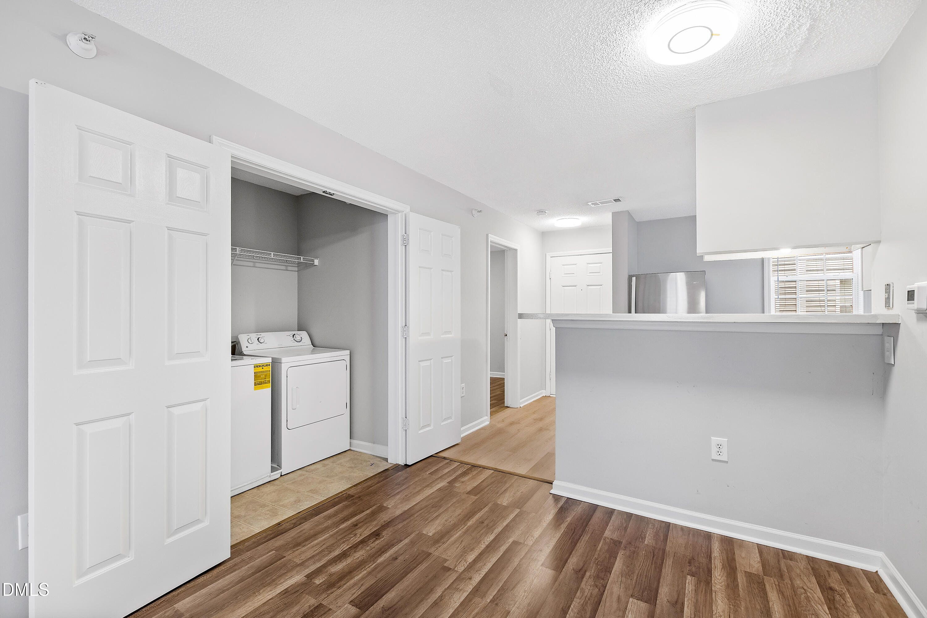 2100 Wolf Tech Lane, Unit 204 Raleigh, NC 27603 - Photo 12 of 40 a view of a kitchen with wooden floor and electronic appliances