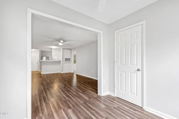 a view of kitchen and hall with wooden floor
