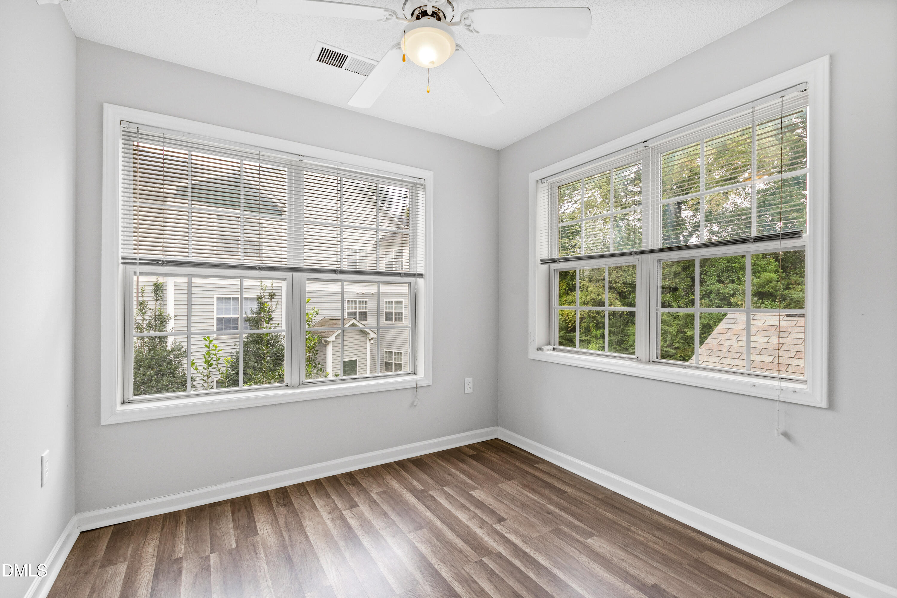 2100 Wolf Tech Lane, Unit 204 Raleigh, NC 27603 - Photo 16 of 40 a view of an empty room with wooden floor and a window