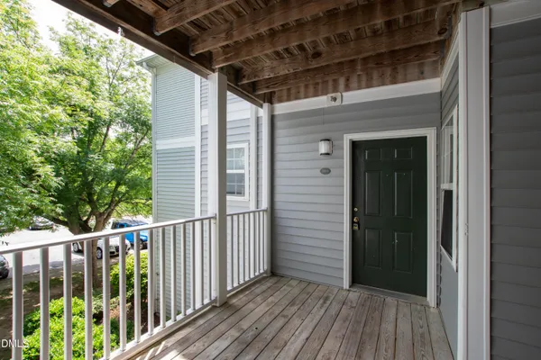 a view of a balcony with wooden floor