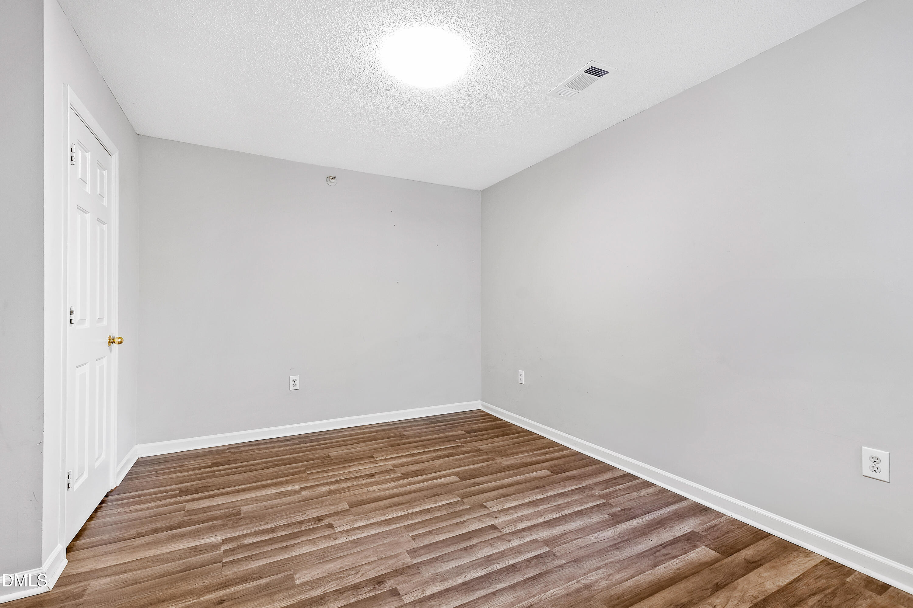 2100 Wolf Tech Lane, Unit 204 Raleigh, NC 27603 - Photo 20 of 40 a view of an empty room with wooden floor
