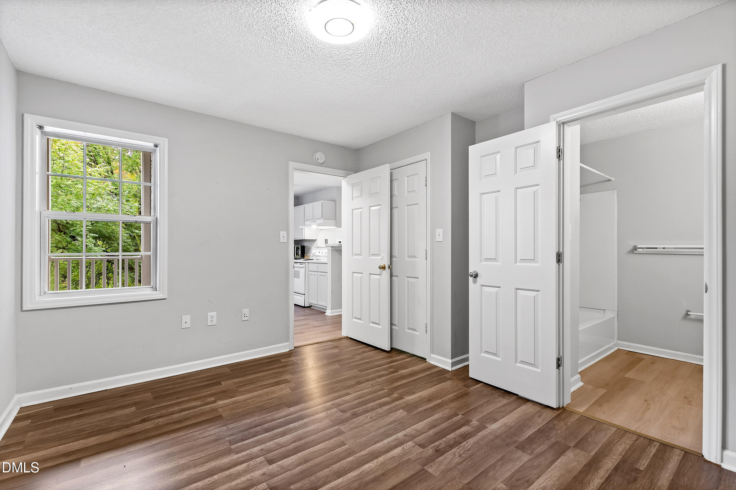 2100 Wolf Tech Lane, Unit 204 Raleigh, NC 27603 - Photo 21 of 40 a view of an empty room with wooden floor and a window