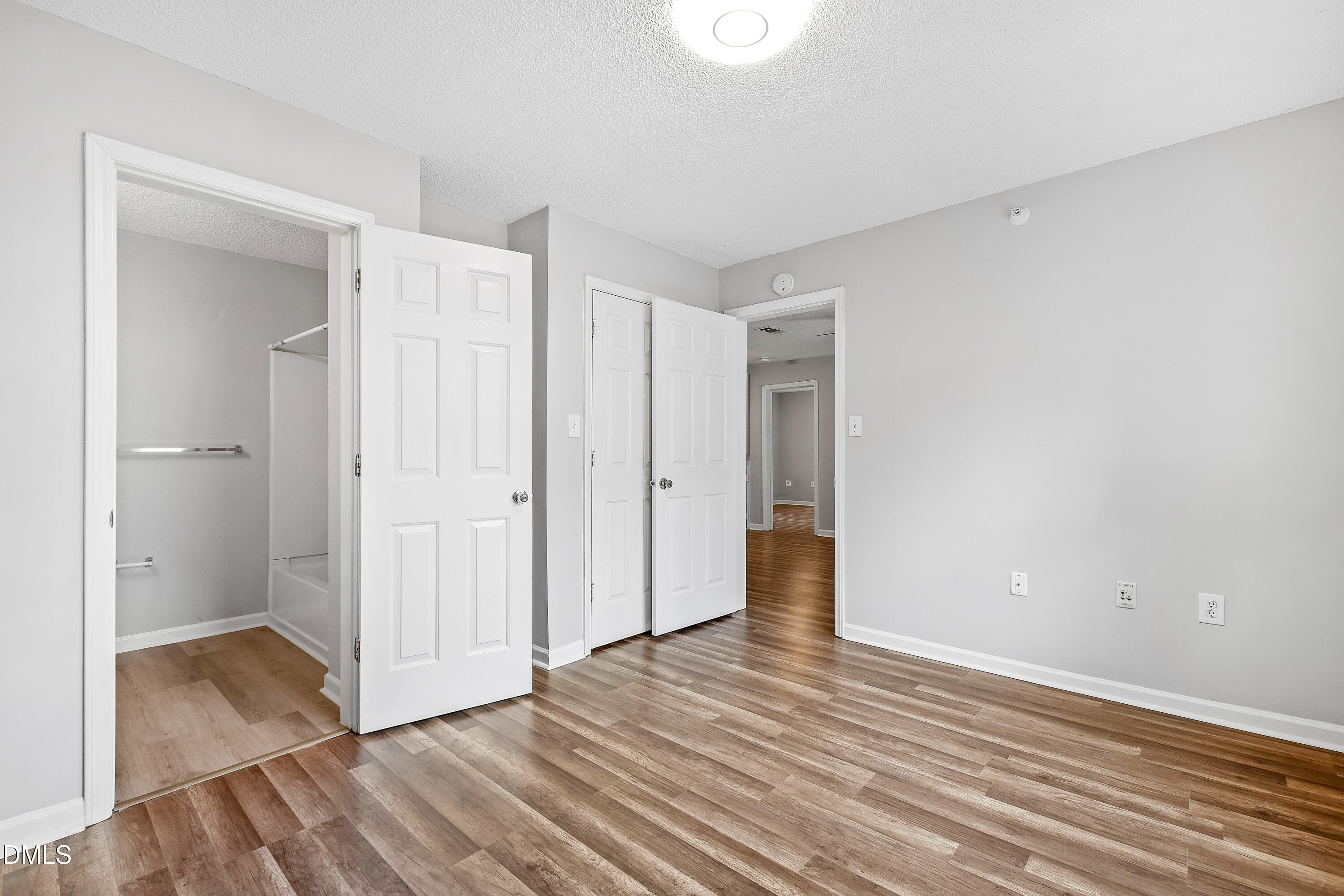 2100 Wolf Tech Lane, Unit 204 Raleigh, NC 27603 - Photo 26 of 40 a view of an empty room with wooden floor and closet