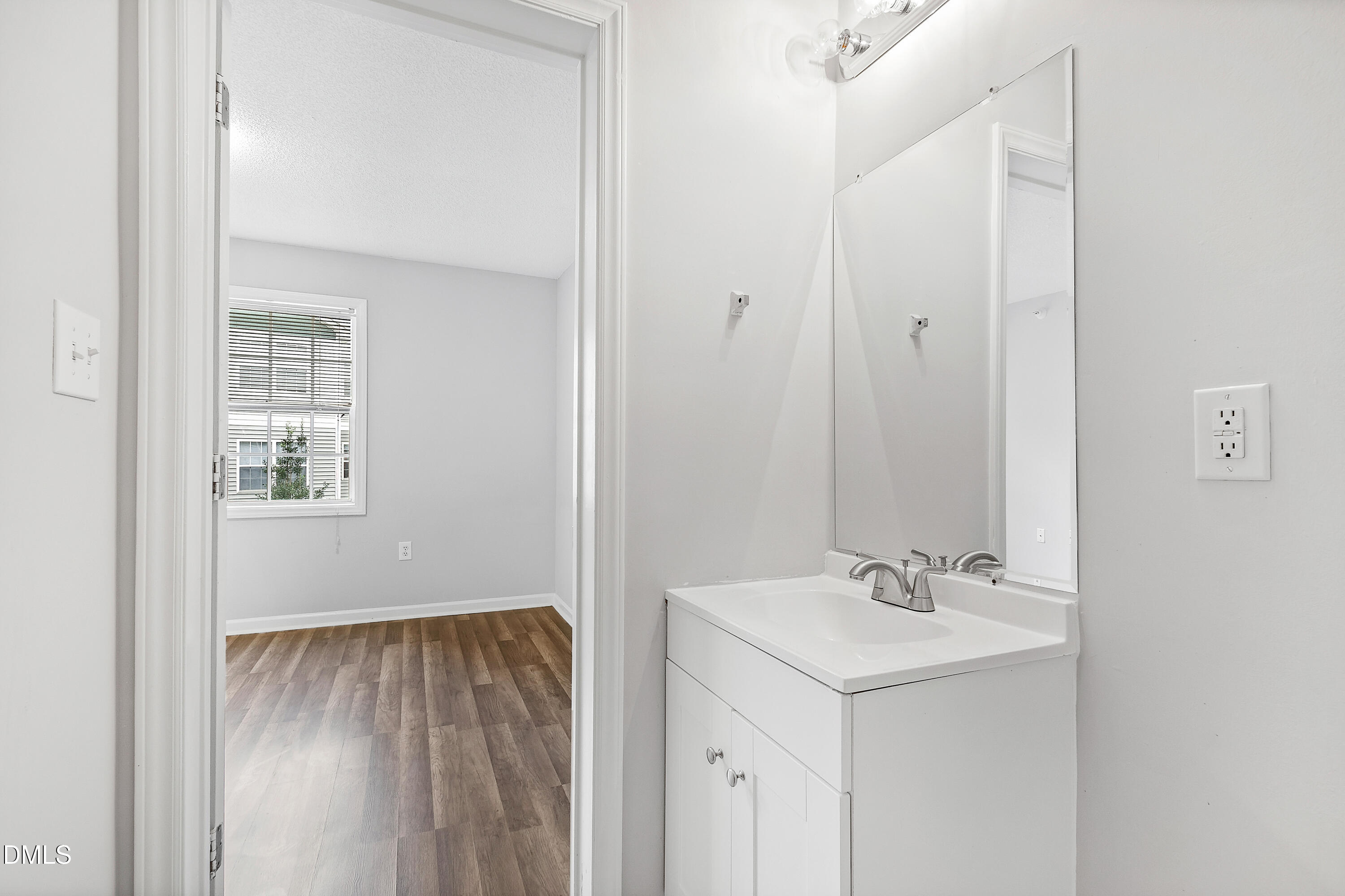 2100 Wolf Tech Lane, Unit 204 Raleigh, NC 27603 - Photo 28 of 40 a bathroom with a sink and a mirror