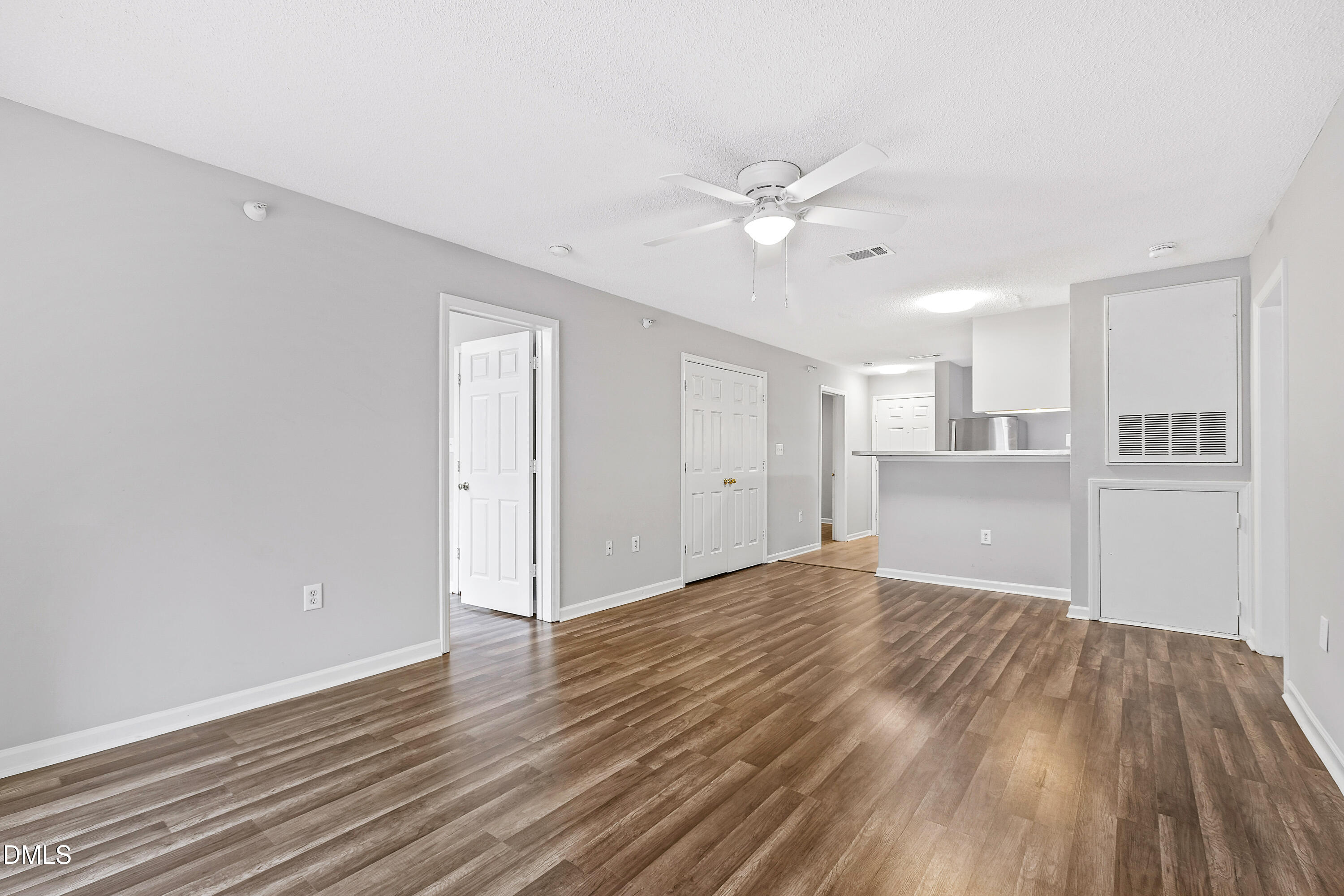 2100 Wolf Tech Lane, Unit 204 Raleigh, NC 27603 - Photo 3 of 40 a view of a kitchen with wooden floor and a ceiling fan