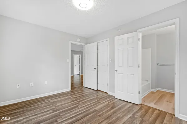 a view of an empty room and wooden floor