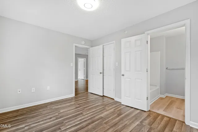 a view of an empty room and wooden floor