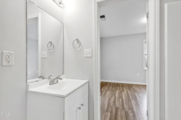 a bathroom with a sink a mirror and a shower