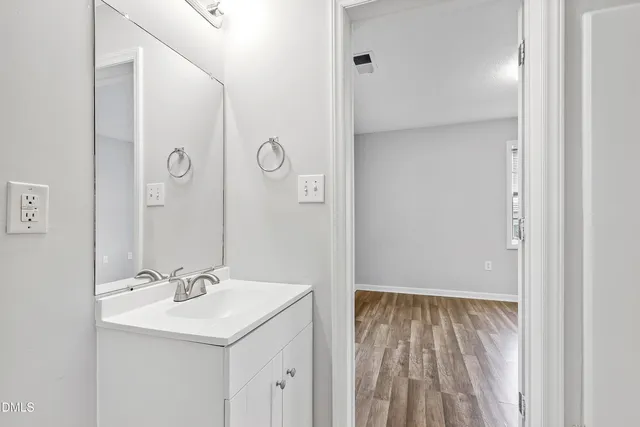 a bathroom with a sink a mirror and a shower