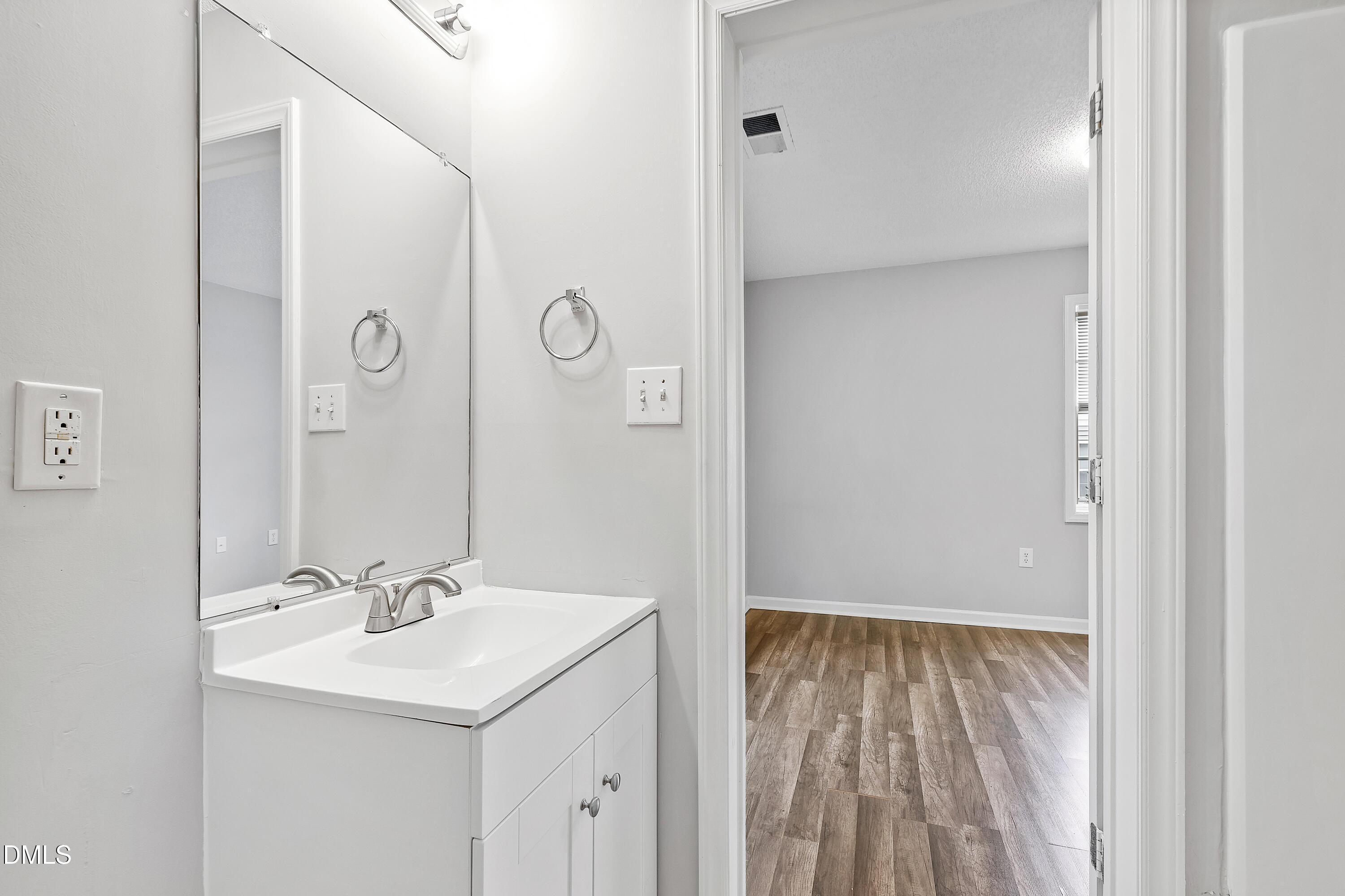 2100 Wolf Tech Lane, Unit 204 Raleigh, NC 27603 - Photo 33 of 40 a bathroom with a sink a mirror and a shower