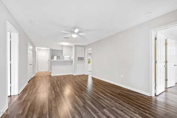 a view of a kitchen with wooden floor and a kitchen