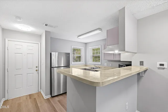 a kitchen with a sink appliances and cabinets