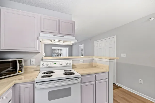 a kitchen with a stove and a microwave