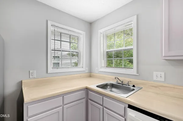 a kitchen with a sink and large window