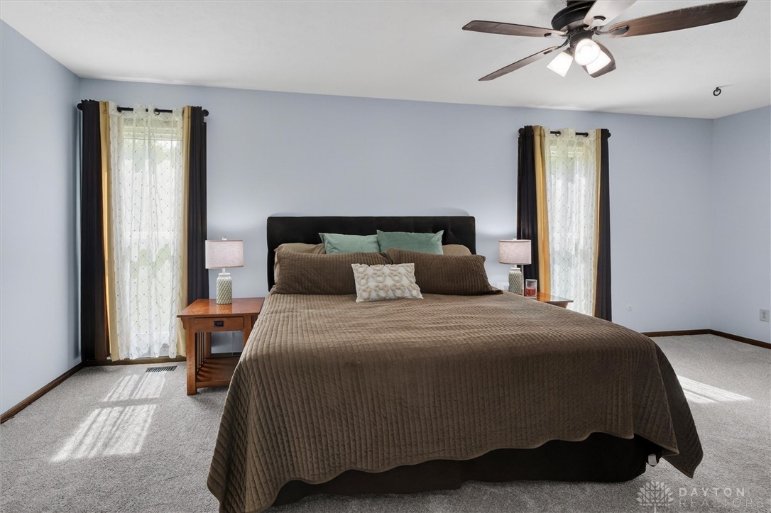 2165 Stewart Road Xenia, OH 45385 - Photo 33 of 59 This spacious bedroom offers a tranquil retreat with soft carpet and ample natural light.