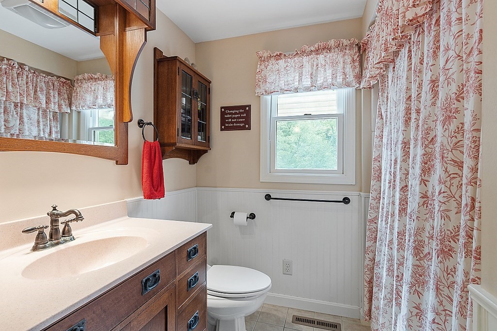113 Green Road Bolton, MA 01740 - Photo 14 of 41 a bathroom with a sink toilet a mirror and a window