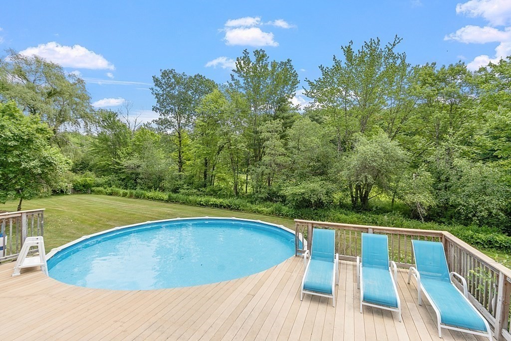 113 Green Road Bolton, MA 01740 - Photo 2 of 41 a view of a swimming pool with a patio