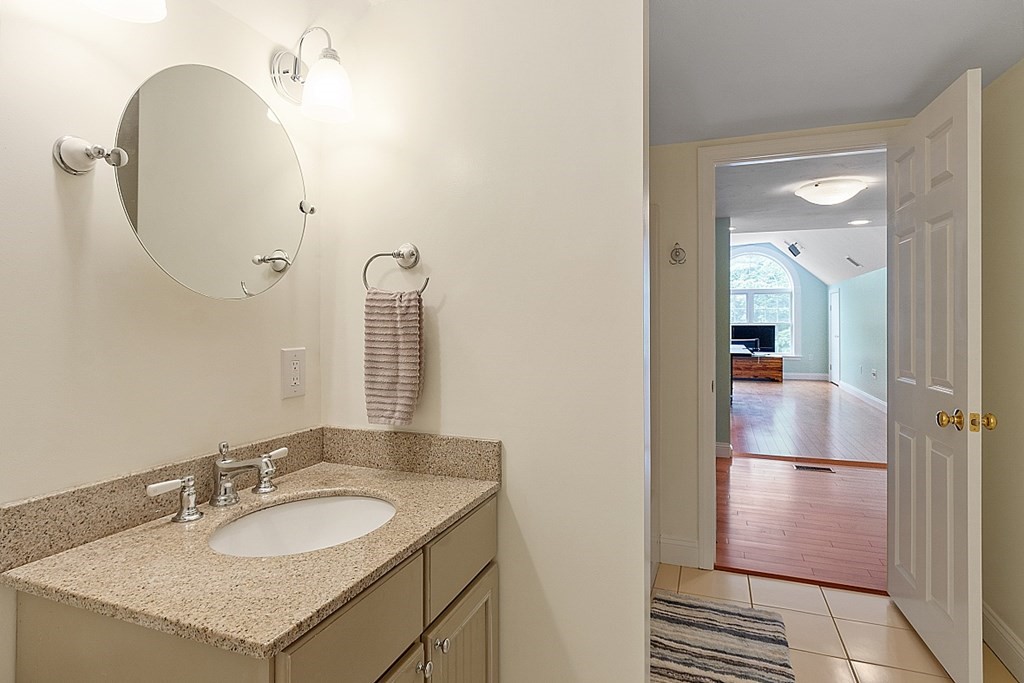 113 Green Road Bolton, MA 01740 - Photo 27 of 41 a en suite bathroom with a granite countertop sink and a mirror