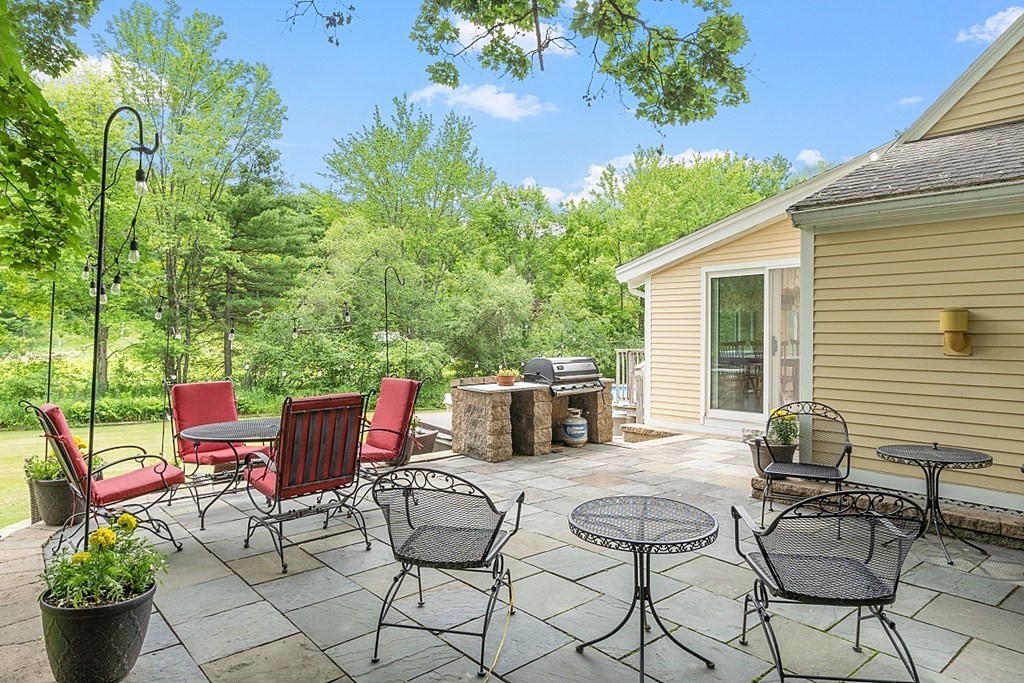 113 Green Road Bolton, MA 01740 - Photo 31 of 41 a view of a chairs and table in the patio