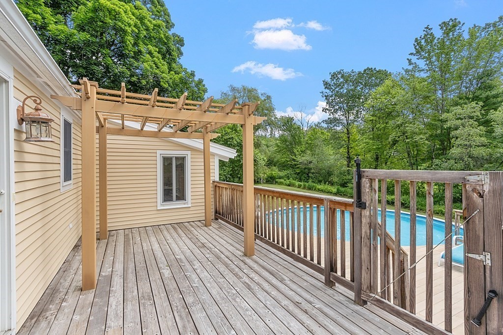 113 Green Road Bolton, MA 01740 - Photo 36 of 41 a view of a wooden deck with a yard