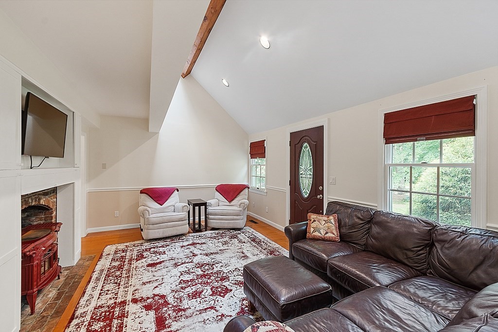 113 Green Road Bolton, MA 01740 - Photo 4 of 41 a living room with furniture fireplace and flat screen tv