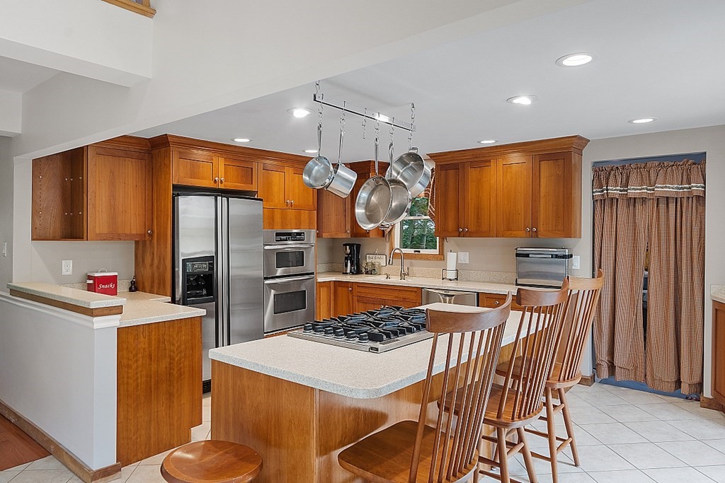 113 Green Road Bolton, MA 01740 - Photo 5 of 41 a kitchen that has a table and chairs in it