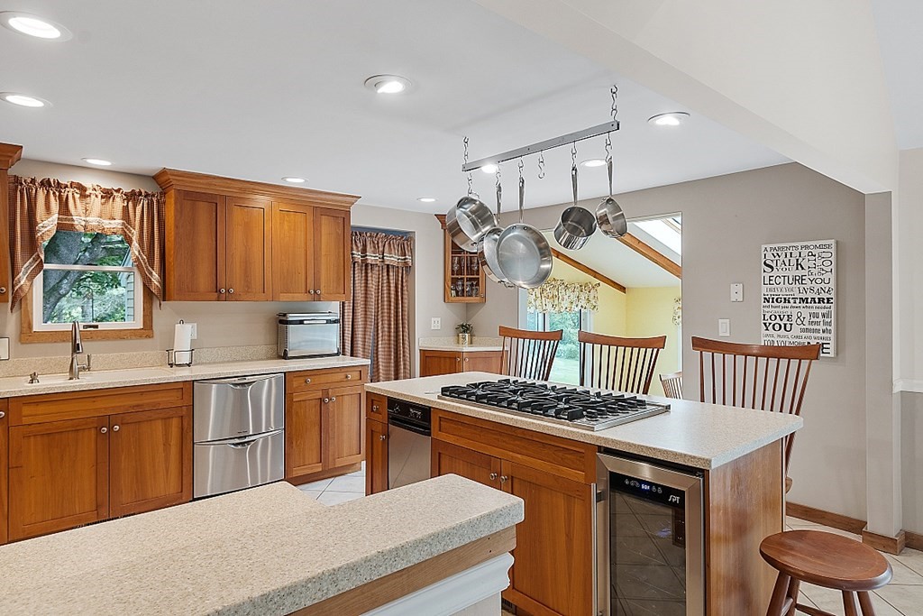 113 Green Road Bolton, MA 01740 - Photo 6 of 41 a kitchen with a stove a sink a refrigerator and blue cabinets with wooden floor