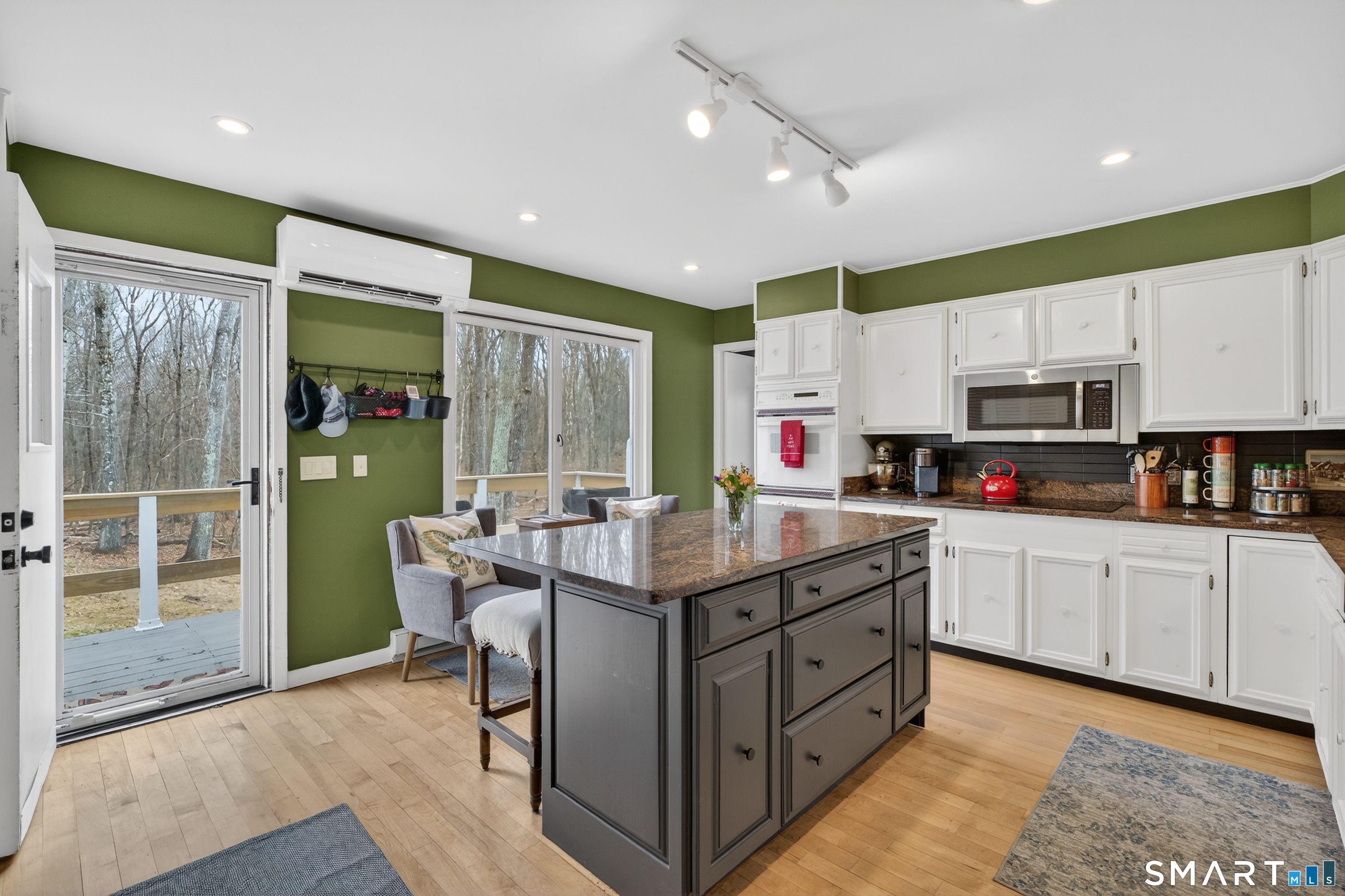 230 Six Rod Highway Hamden, CT 06518 - Photo 12 of 38 a kitchen with stainless steel appliances granite countertop a stove top oven a sink dishwasher and white cabinets with wooden floor