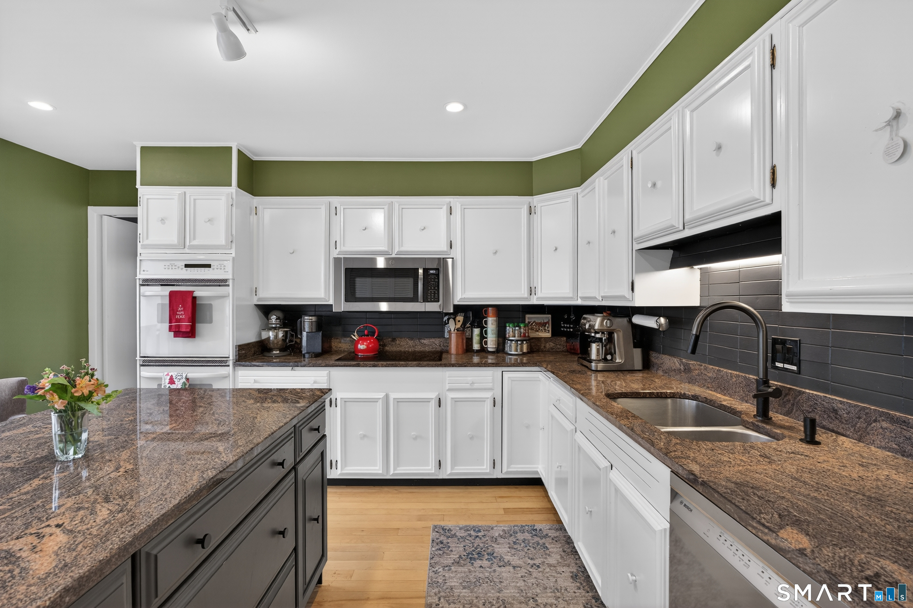 230 Six Rod Highway Hamden, CT 06518 - Photo 13 of 38 a kitchen with granite countertop a sink a stove and cabinets