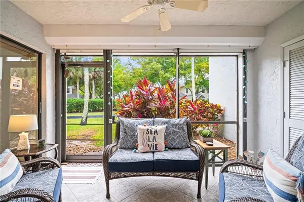 a living room filled with furniture and a large window