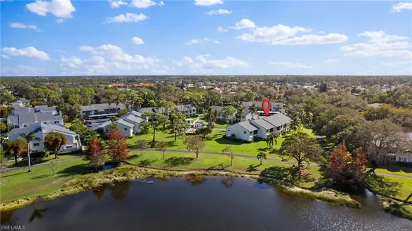 an aerial view of a houses with a yard