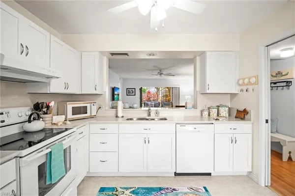 a kitchen with granite countertop a sink and cabinets