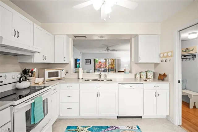 a kitchen with granite countertop a sink and cabinets