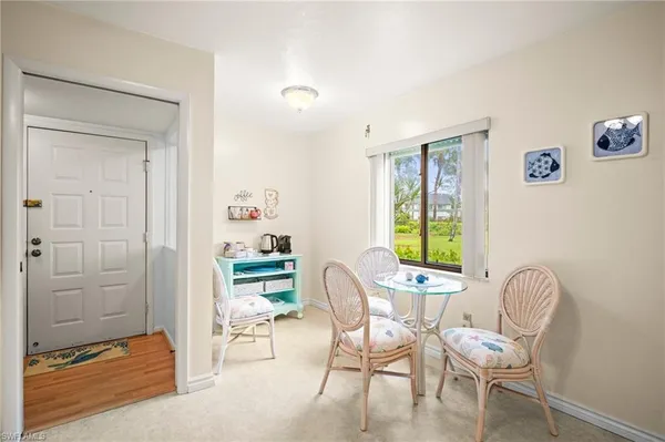 a dining room with furniture and window