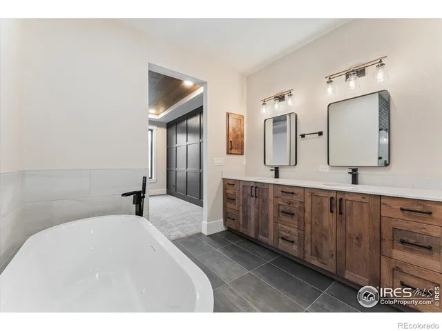a bathroom with a granite countertop sink a toilet mirror and bathtub
